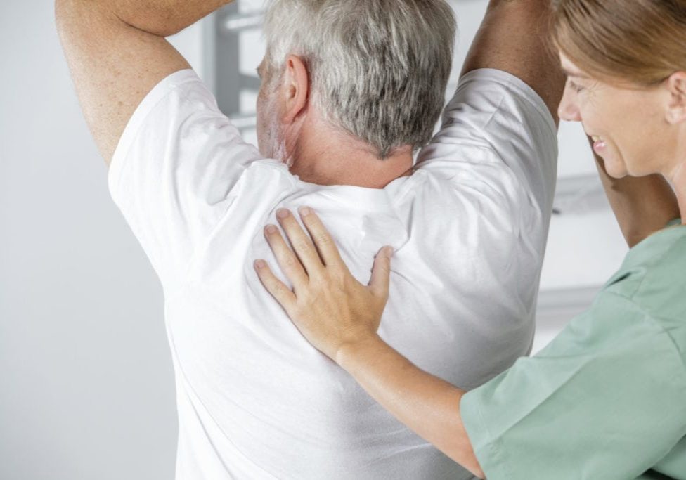 Elderly man in rehab with nurse