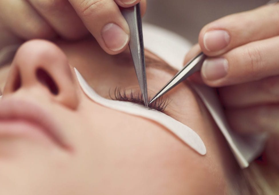 Traditional eyelash extensions. Selective focus. Toned. Makeup close-up.