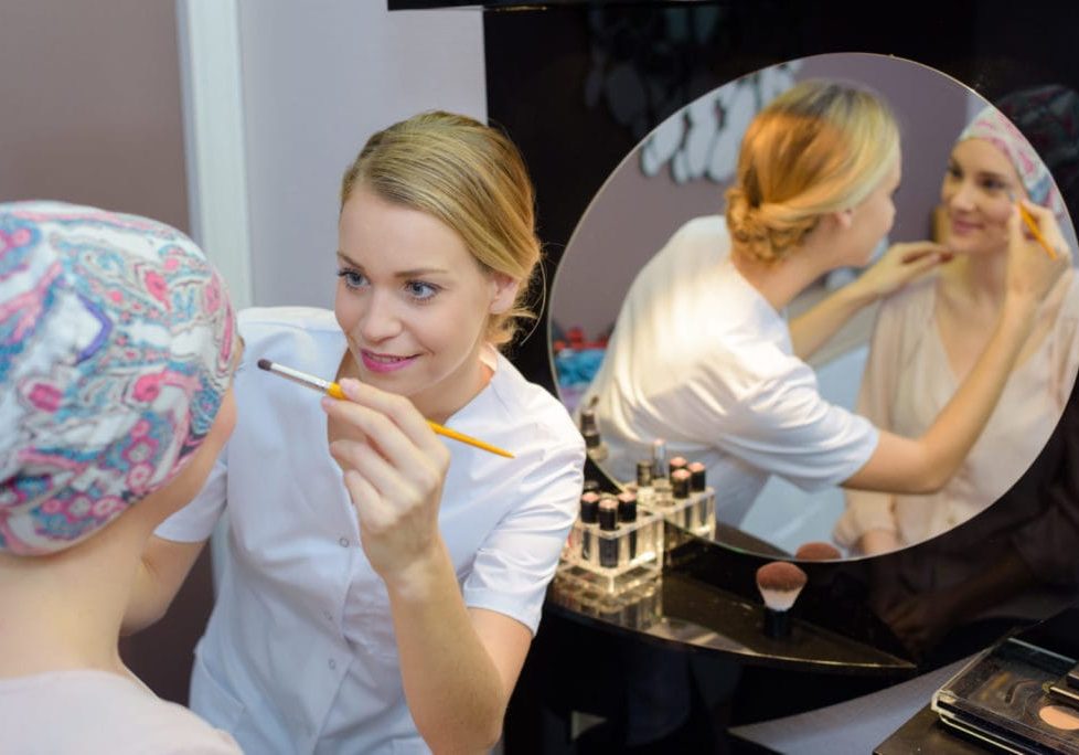 Beautician applying cosmetics