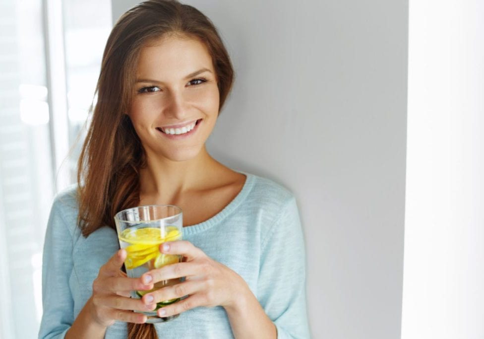 Healthy Lifestyle, Food. Happy Woman Drinking Summer Refreshing Fruit Flavored Infused Water With Fresh Organic Lemon, Lime, Mint. Detox Vitamin-fortified Water. Healthy Eating. Vitamin, Diet Concept.