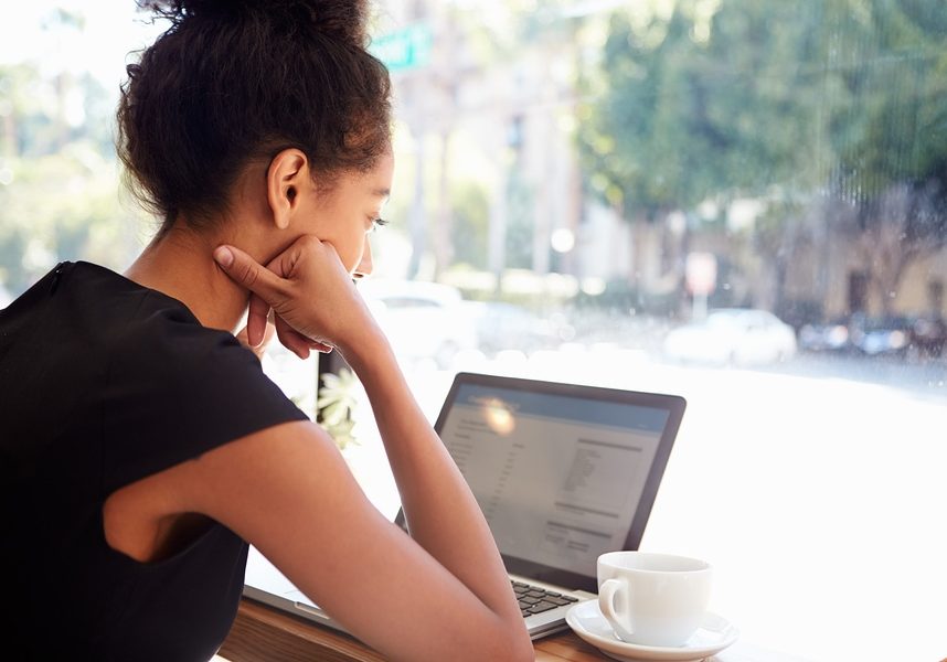 Businesswoman Using Laptop In Coffee Shop