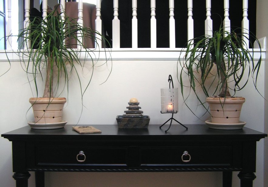 photo of a table in the entryway of a home with a feng shui theme.