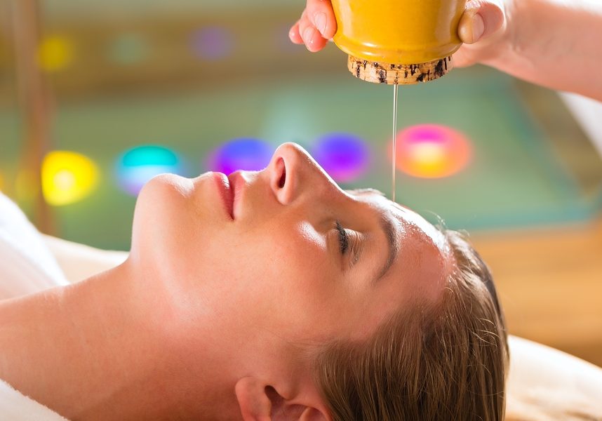 Woman enjoying a Ayurveda oil massage treatment in a spa