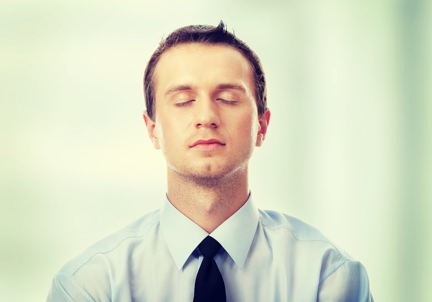 Yound caucasian business man meditating