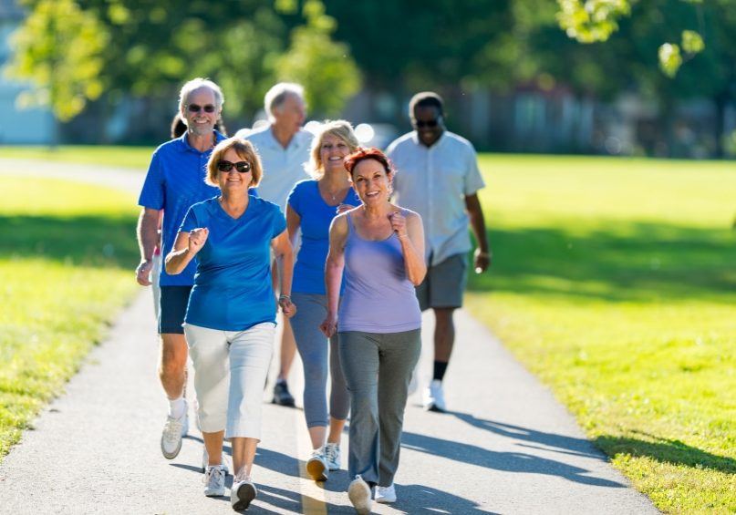 Mature adults exercising in the park.